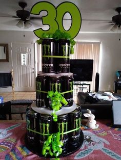 there is a cake made to look like the number 30 on top of each beer cans