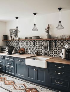 a kitchen with blue cabinets and an area rug