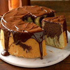 a chocolate cake on a plate with one slice cut out