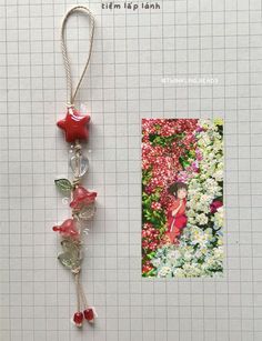 an ornament hanging from a string next to flowers