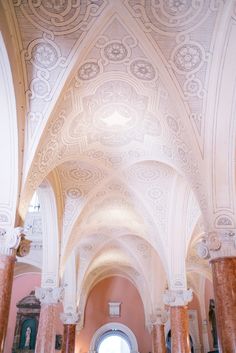 the inside of a church with columns and arches