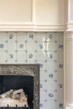 a fireplace with blue and white tiles on it