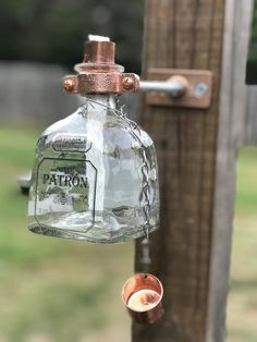 a glass bottle hanging from a wooden post