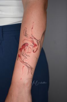 a woman with a tattoo on her arm that has a koi fish on it