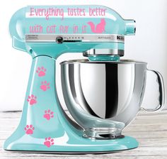 a blue mixer with pink paw prints on it and the words, everything tastes better