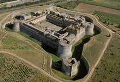 an aerial view of a castle in the middle of nowhere