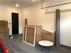 a room filled with boxes and furniture next to a fire place