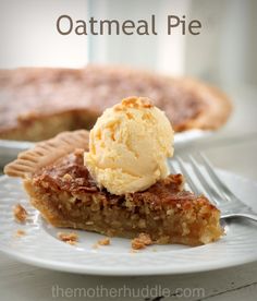 a piece of pie with ice cream on top is sitting on a plate next to a fork