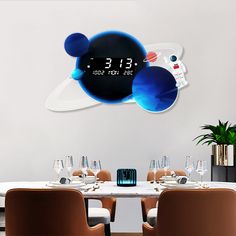 a table with chairs and a clock on the wall above it that reads 3 13