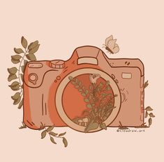 an orange camera sitting on top of a table next to a leafy plant and butterfly