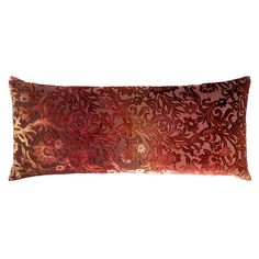 a red and gold decorative pillow on a white background