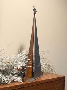 a small metal christmas tree on top of a wooden box