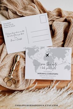 the wedding stationery is laid out on top of a furnishing area with a pair of gold scissors