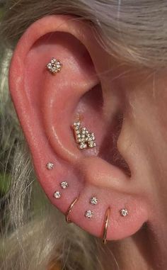 a woman with three different piercings on her ear