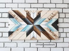 a white brick wall with a wooden sign on it that says umman woodwork