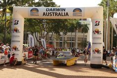 a race car is parked under an arch at the start line for a race in australia