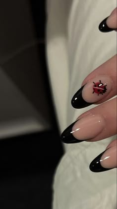 a woman's hand with black and white nail art on it