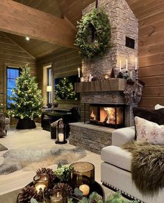 a living room filled with furniture and a fire place in the middle of a wooden wall