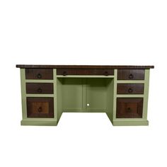 a green desk with two drawers on it