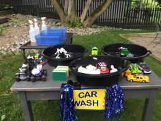 cars and toys are sitting on the table outside