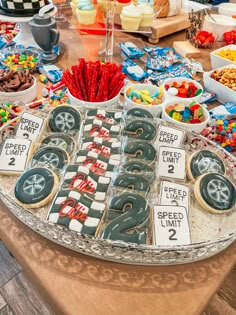 a table filled with lots of desserts and sweets on top of each other at a party