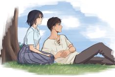 two people sitting next to each other in the grass