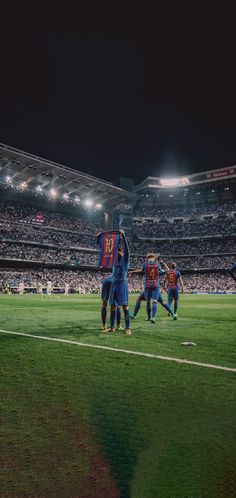 a group of men standing on top of a soccer field