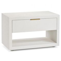 a white table with a drawer on the bottom and gold handles in front of it