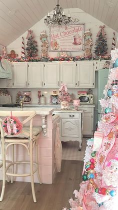 a kitchen decorated for christmas with pink and green decorations