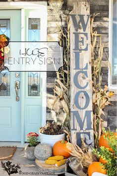 a welcome sign on the front door of a house with flowers and wreath in it