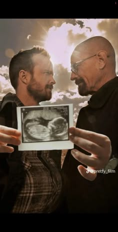 two men are looking at an x - ray image