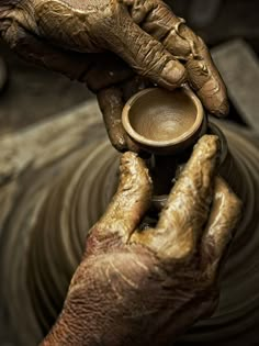 a poster with an image of a potter's hands holding a clay pot