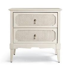 a white nightstand with two drawers and wicker handles on the bottom, against a white background