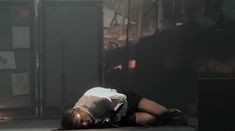 a person laying on the ground with their head down