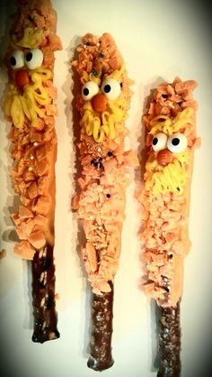 some kind of food with googly eyes on it's sides and two sticks in the shape of sesame street characters