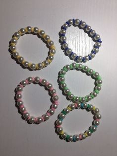 four bracelets with different colored beads on them