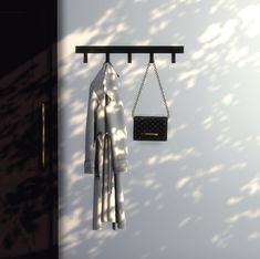 a coat and purse hanging on a wall