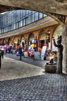 an open air market with people walking around