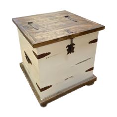 a white and brown wooden box sitting on top of a table