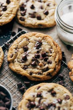 chocolate chip cookies cooling on a wire rack next to a jar of salt and pepper