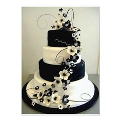 a black and white wedding cake decorated with flowers