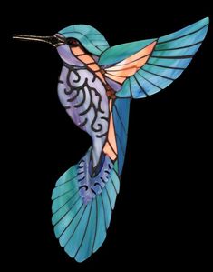 a blue and orange hummingbird flying in the air