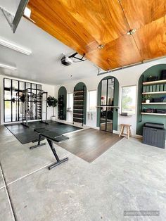 an empty gym with tables and exercise mats