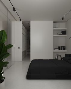 a black and white bedroom is shown with bookshelves on either side of the bed