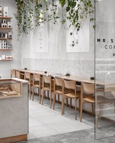 the interior of a coffee shop with tables and chairs