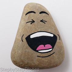 a rock with a face painted on it