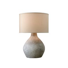 a table lamp with a white shade on it's base and a beige drum light