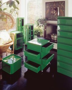 a living room filled with lots of green furniture