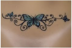 a blue butterfly tattoo on the back of a woman's neck and shoulder,