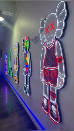 neon signs on the side of a wall with an image of a person in a basketball uniform